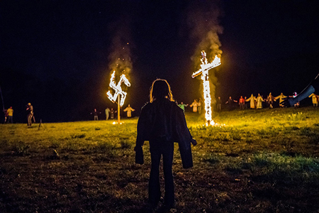 The burning of a Swastika and Cross.